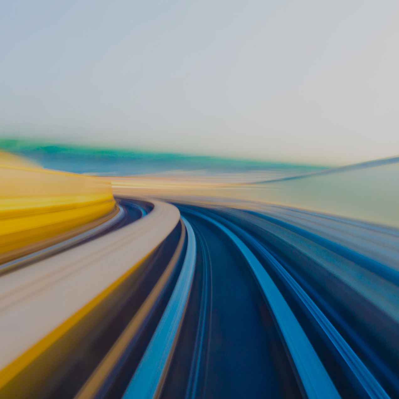 Curved roadway streaking through a colourful blurred landscape
